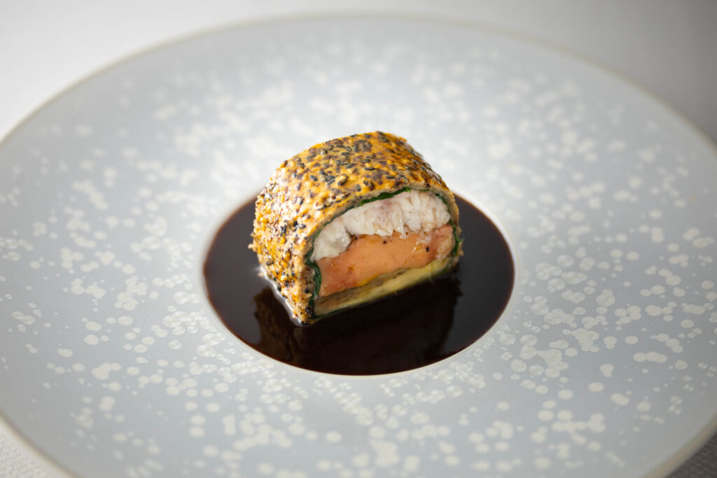 Professional chef tasting a dish featuring Hamanatto