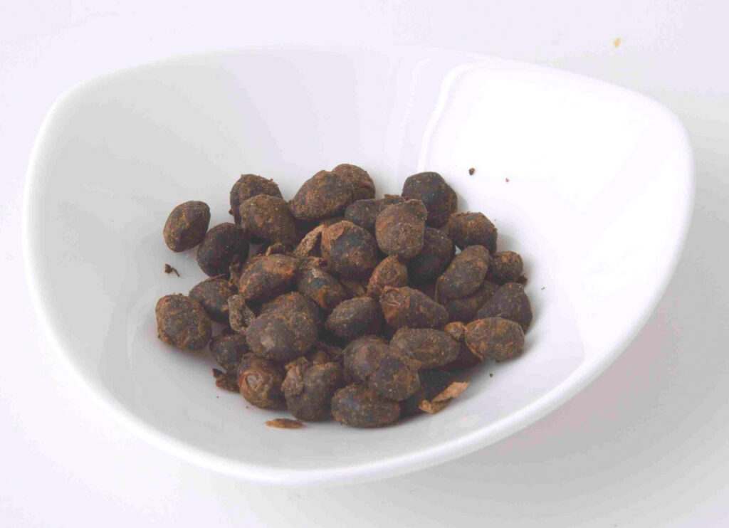 Close-up of whole Hamanatto soybeans showing their dense aged texture