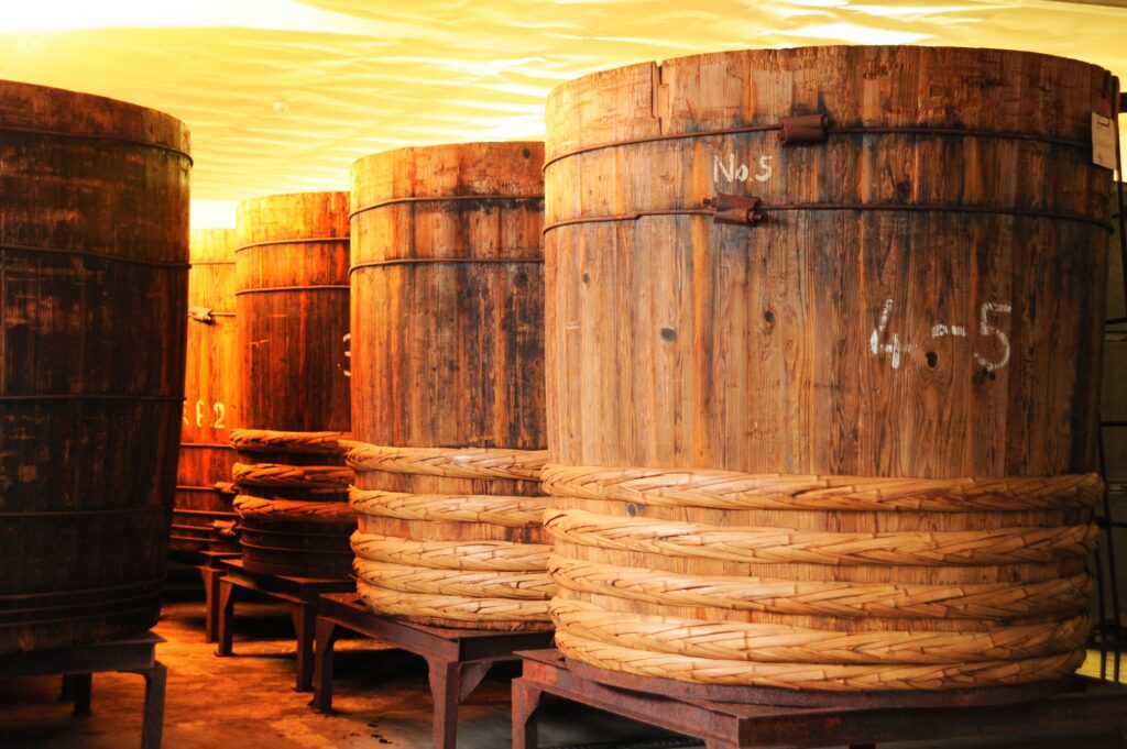 Traditional wooden fermentation barrels used for long-term Japanese soybean fermentation.